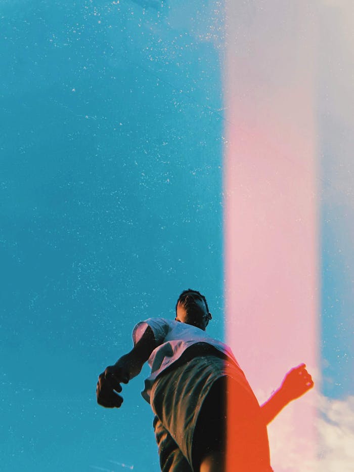 Man standing under pure blue sky